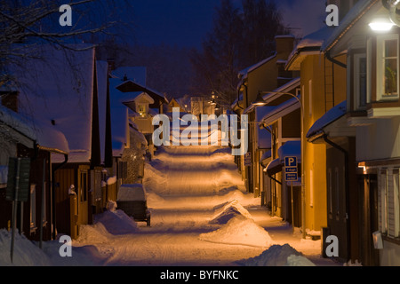 Snow covered buildings and street at dawn Stock Photo