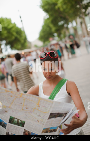 Mid adult woman reading map Stock Photo