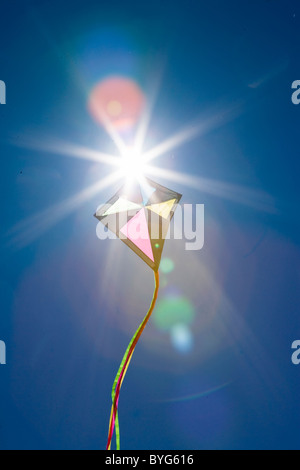 Backlit kite against clear blue sky Stock Photo