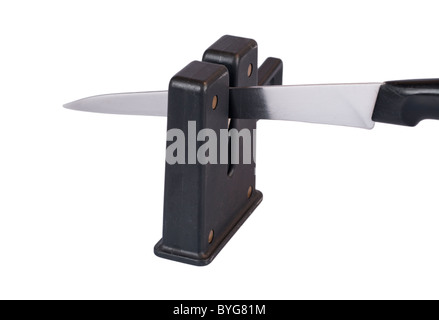 Sharpening a Kitchen Knife Blade with a Sharpener on a White Background Stock Photo