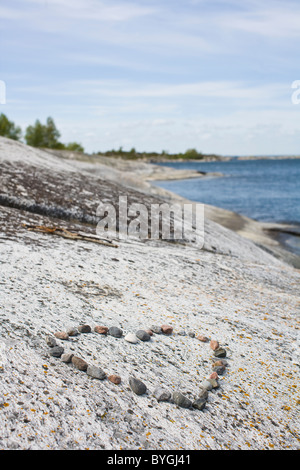 Pebbles in shape of heart on beach Stock Photo