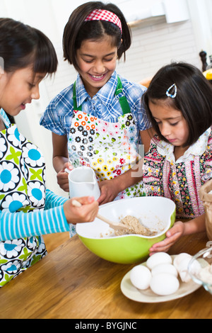 Three girls baking in kitchen Stock Photo