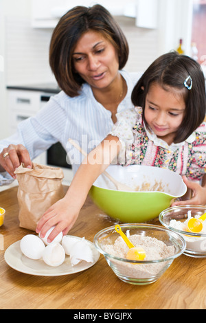 Mother baking with daughter in kitchen Stock Photo