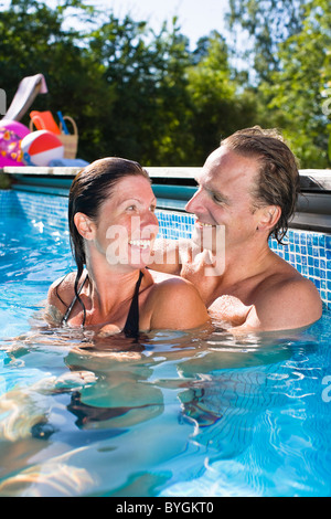 Portrait of couple in swimming pool Stock Photo