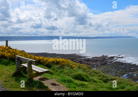 A bench on the cliffs overlooking the sea and Cornborugh Range near Abbotsham, Devon, England. Stock Photo