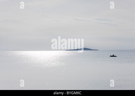 View of sea with boat in distance Stock Photo