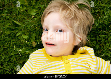 Portrait of boy lying on grass Stock Photo