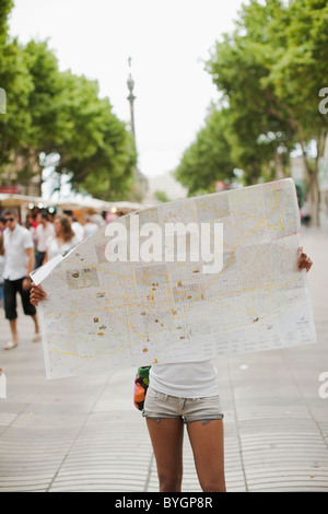 Mid adult woman reading map Stock Photo