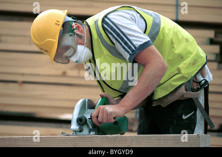 Carpentry and Joinery. Operating a circular portable saw. Stock Photo