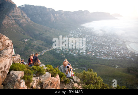 People sitting at peak on Lions Head waiting for sun to set Stock Photo