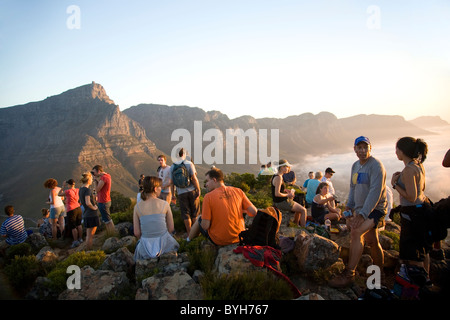 Hikers on top of Lions Head in cape Town with view of 'Twelve Apostles' Stock Photo