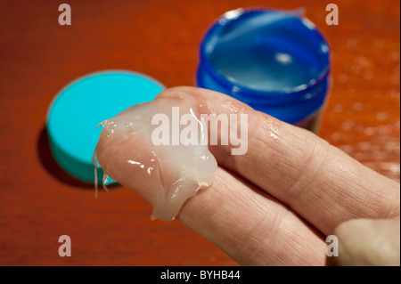A dab of Vicks Vaporub cold remedy on a man's fingers Stock Photo