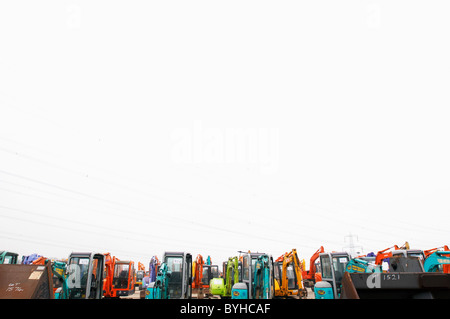 Mini-diggers lined up on a yard Stock Photo
