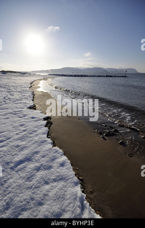 West shore Llandudno  winter coastal scene looking towards Conwy Mountain Stock Photo