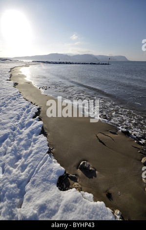 West shore Llandudno  winter coastal scene looking towards Conwy Mountain Stock Photo