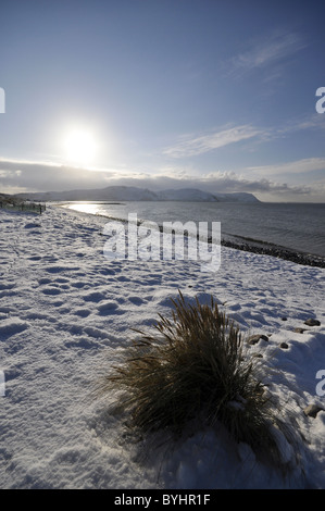 West shore Llandudno  winter coastal scene looking towards Conwy Mountain Stock Photo