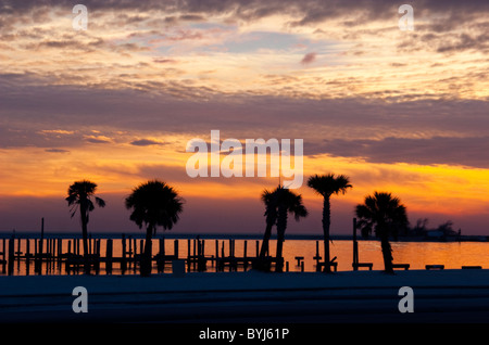 Pier destroyed by hurricane Katrina in silhouette against a sunset in Biloxi, Mississippi. Stock Photo