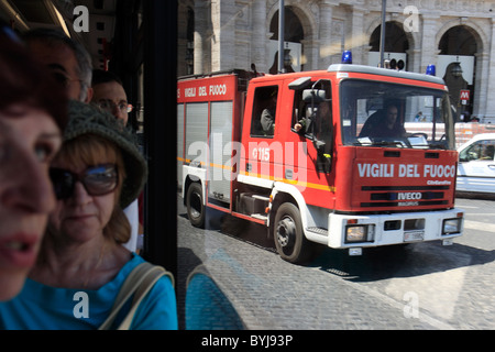 A fire engine overtaking a bus, Rome, Italy Stock Photo