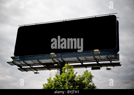 Black blank advertising billboard over sky Stock Photo
