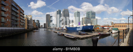 a panoramic view of canary wharf from West India Docks on a sunny day Stock Photo