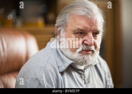 Older man with black eye, beard and white hair, serious expression Stock Photo
