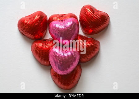 Pink and red foil wrapped heart shaped chocolates arranged in shape of heart for Valentine day, Valentines day Stock Photo