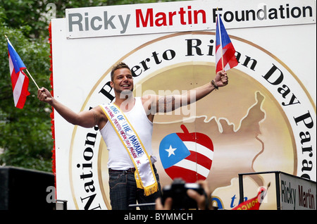 Ricky Martin, smiles as he waves his flags during The 50th annual National Puerto Rican Day parade along 5th Avenue New York Stock Photo