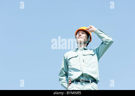 Young Man in Uniform and Hardhat Stock Photo