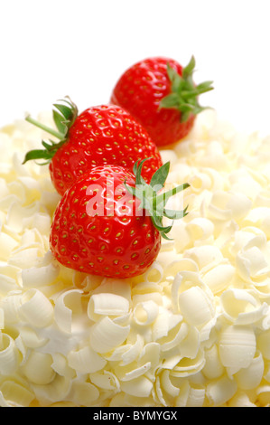 Three Strawberries on White Chocolate Cake Stock Photo