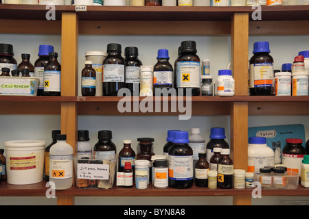 Shelves of assorted chemicals in a school chemical storage room in England. Stock Photo