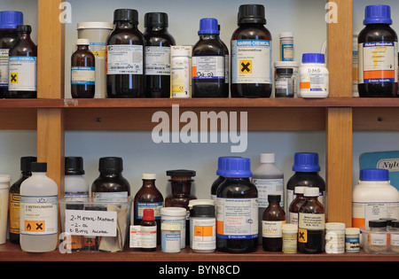 Shelves of assorted chemicals in a school chemical storage room in England. Stock Photo