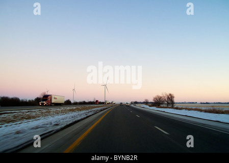 Wind turbines and Interstate 65. Indiana. Cruising southbound on Interstate 65 in Indiana at twilight in winter. Stock Photo