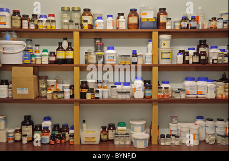 Shelves of assorted chemicals in a school chemical storage room in England. Stock Photo