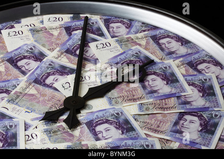 Twenty Pound Notes on Clock Face with Hands Stock Photo