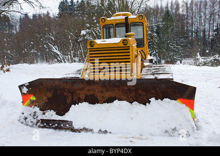 Bulldozer in the snow in winter Stock Photo