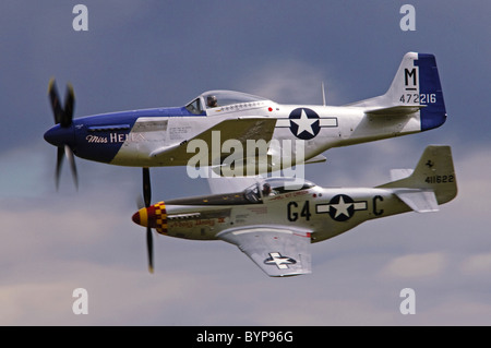 P-51 Mustang pair. These North American P-51D Mustang planes performed a low-level flypast at the Duxford Flying Legends airshow. Stock Photo
