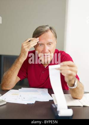 Senior man worried about his home finances. Stock Photo