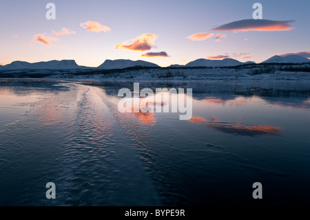 reflection of the famous 'lappenforte' Mountains in frozen lake Tornetraesk, Abisko, Lapland, Sweden Stock Photo