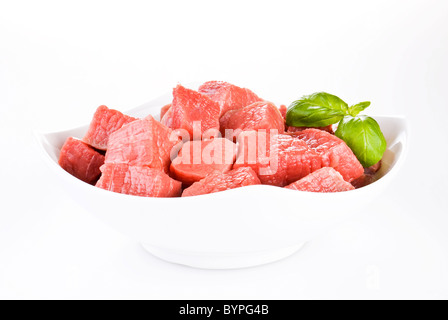 Bowl of diced beef over white background Stock Photo