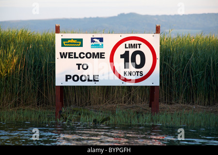 Welcome to Poole limit 10 knots - sign along Wareham river, Dorset UK in July Stock Photo