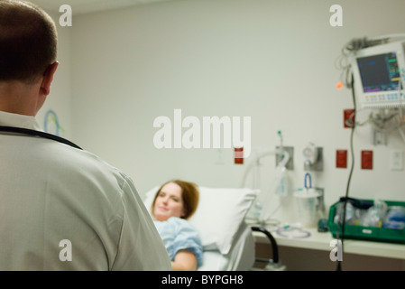 Doctor talking with patient in hospital Stock Photo