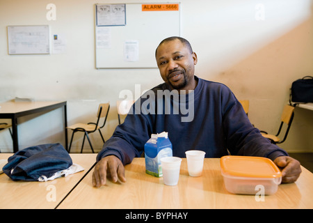 Factory worker having lunch in breakroom Stock Photo