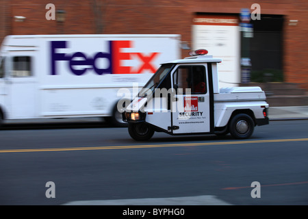 Fedex delivery van goes passed a New york police surveillance vehicle 2010 Stock Photo