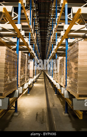 Automated Storage and Retrieval System, AS/RS, operating in the dark to conserve energy in warehouse Stock Photo