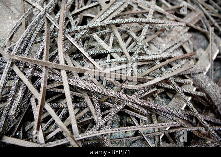 Trimmed edges from carpet tiles set aside for recycling Stock Photo