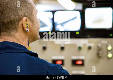 Textile worker watching control panel in carpet tile factory Stock Photo