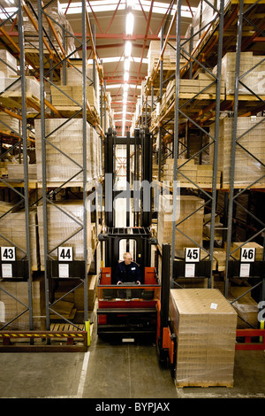 Forklift moving pallets in warehouse Stock Photo