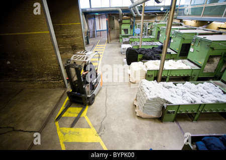 Carpet tile factory, forklift preparing fluffy fibers for processing Stock Photo