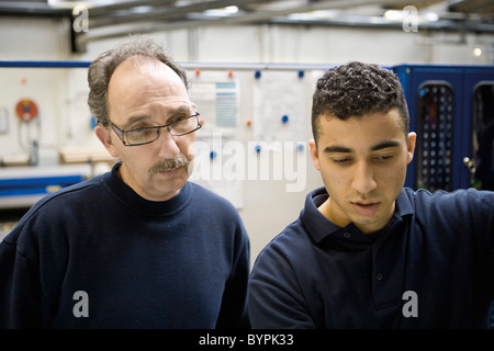 Textile workers talking in factory Stock Photo