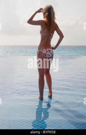 Young Woman in Bikini Looking out to the Sea, Cancun Mexico Stock Photo